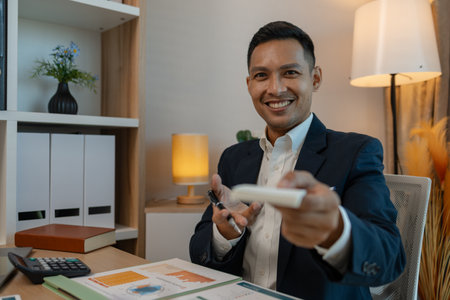 portrait of successful businessman looking at camera and smiling inside modern office, smiling confident business leader looking at camera, happy middle aged business man entrepreneurの写真素材