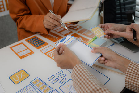 the development team is consulting on the design of the website UX UI, they are working on project of ux ui, interface, innovation of ux ui, develop team are discussing about their projectの写真素材