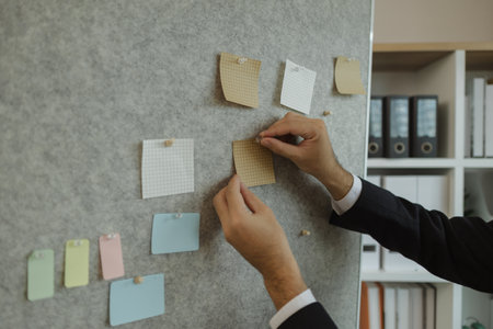 A businessman is planning a strategy to work efficiently and have the most positive impact on the company. An executive of a company is organizing ideas into a concrete form for easy understanding.の写真素材