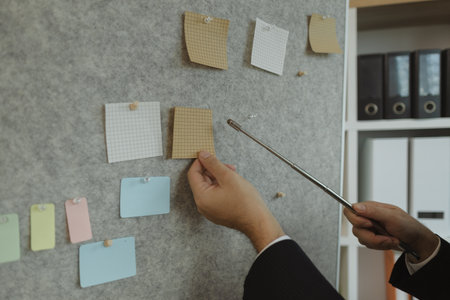 A businessman is presenting an earnings report to the board of directors with great attention. Data and documents are presented and explained in the meeting by a businessman.の写真素材