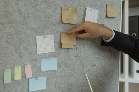 A businessman is presenting an earnings report to the board of directors with great attention. Data and documents are presented and explained in the meeting by a businessman.の写真素材