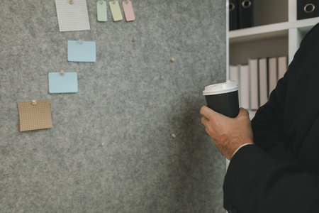 A businessman is planning a strategy to work efficiently and have the most positive impact on the company. An executive of a company is organizing ideas into a concrete form for easy understanding.の写真素材