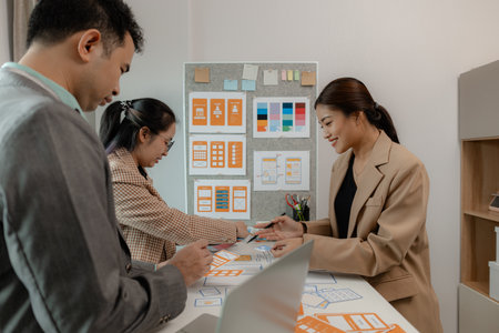 The web design team is consulting to exchange ideas on how to develop digital products that are modern and user-friendly, suitable for today's users, ux ui teamの写真素材
