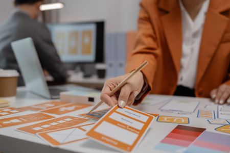 ux developer and ui designer brainstorming about mobile app interface wireframe design in the office, website designer, creative planning phone app development templateの写真素材