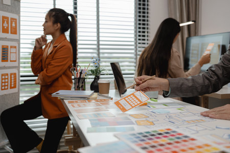 drawing website ux ui app for mobile phone application and development template layout, UI development, designer team working on a project of ux ui in creative office, team of creative webの写真素材