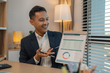 businessman giving presentation in office, an investor pitching to a room with charts and graphs showing the potential of renewable investments, presenting an accounting reportの写真素材