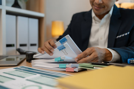stamped the document to approve, businessman professional working while sitting at office desk, accountant, marketing, employee is working alone in the office, approving report,の写真素材