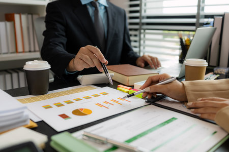 they are working on the new project together in the office, a lot of paperwork on the desk that this group of businessman have to working on, business meeting, workplace, businesspeopleの写真素材