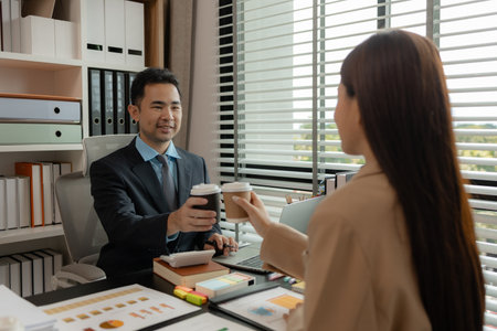 a group of businessman is meeting in the office in the morning with their coffee, colleagues sit together having some coffee in the workplace, businesspeople discussion about their new projectの写真素材