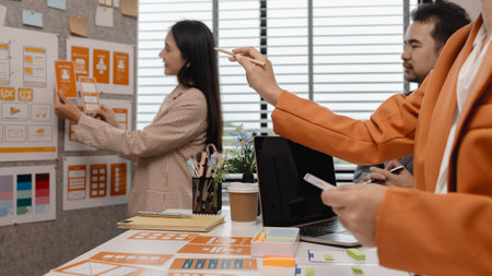 ux developer and ui designer brainstorming about mobile app interface wireframe design in the office, website designer, creative planning phone app development templateの写真素材