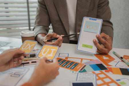 UX graphic designer planning application process development prototype, software development team, copy space, collaboration UX developer and UI designer, team analyzing mobile app interfaceの写真素材
