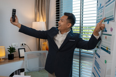 a businessman is talking on the phone with his colleague, a man is working in the office at company of accountant, an employee is in his private officeの写真素材