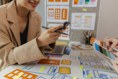 Web designers are working hard to design the appearance of digital products that are colorful, attractive, and user-friendly, while also not cumbersome for users to use.の写真素材