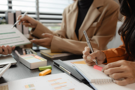 Several employees work together in a company, A group of business people sit together and discuss and exchange ideas about the content of the work, colleagues planning together in the officeの写真素材