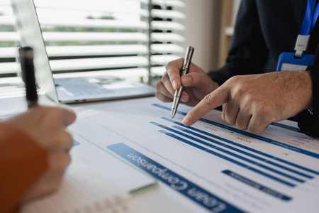 Office workers work together in a company, businessmen are sitting and negotiating about their joint...