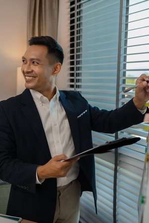 businessman giving presentation in office, an investor pitching to a room with charts and graphs showing the potential of renewable investments, presenting an accounting reportの写真素材