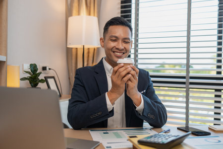 businessman in office relaxing in the office, calm businessman sit relax in his private office workplace take a break, happy relaxed young, man, Asian businessman is relaxing after finishing workの写真素材
