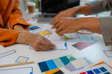 UX graphic designer planning application process development prototype, software development team, copy space, collaboration UX developer and UI designer, team analyzing mobile app interfaceの写真素材