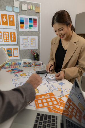 The web design team is consulting to exchange ideas on how to develop digital products that are modern and user-friendly, suitable for today's users, ux ui teamの写真素材