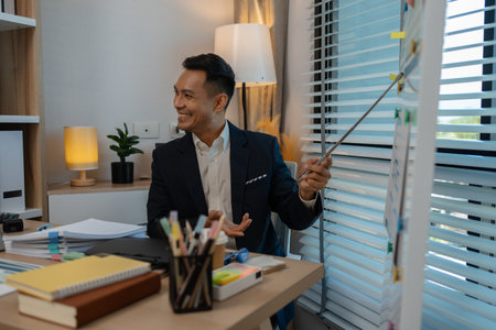 businessman giving presentation in office, an investor pitching to a room with charts and graphs showing the potential of renewable investments, presenting an accounting reportの写真素材