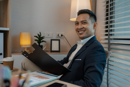 businessman in office relaxing in the office, calm businessman sit relax in his private office workplace take a break, happy relaxed young, man, Asian businessman is relaxing after finishing workの写真素材