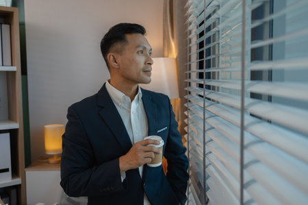 businessman in office relaxing in the office, calm businessman sit relax in his private office workplace take a break, happy relaxed young, man, Asian businessman is relaxing after finishing workの写真素材