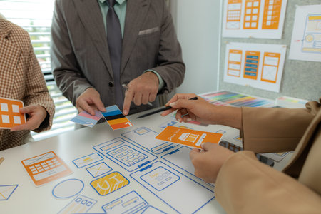 The web design team is consulting to exchange ideas on how to develop digital products that are modern and user-friendly, suitable for today's users, ux ui teamの写真素材