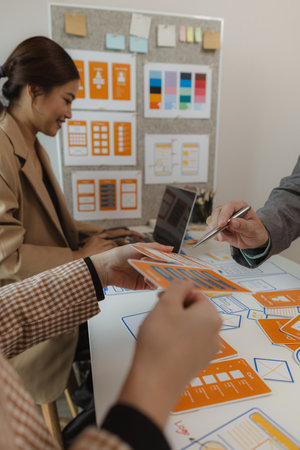 Digital product business owners brainstorm to find conclusions on choosing different website design styles that meet the needs of today's users who need to be easy to use and have a beautiful design.の写真素材