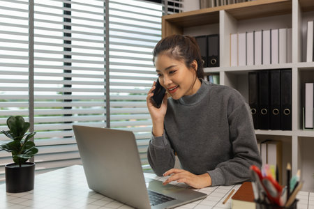 happy woman working on laptop at home office, entrepreneur using laptop at home office, mature businesswoman working from home, beautiful company owner working during isolation periodの写真素材