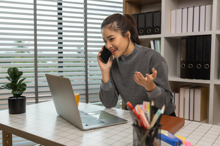 happy woman working on laptop at home office, entrepreneur using laptop at home office, mature businesswoman working from home, beautiful company owner working during isolation periodの写真素材