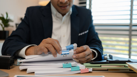 stamped the document to approve, businessman professional working while sitting at office desk, accountant, marketing, employee is working alone in the office, approving report,の写真素材
