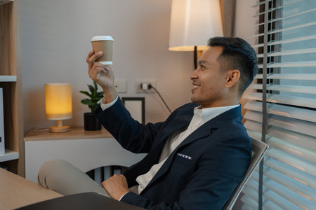 businessman in office relaxing in the office, calm businessman sit relax in his private office workplace take a break, happy relaxed young, man, Asian businessman is relaxing after finishing workの写真素材