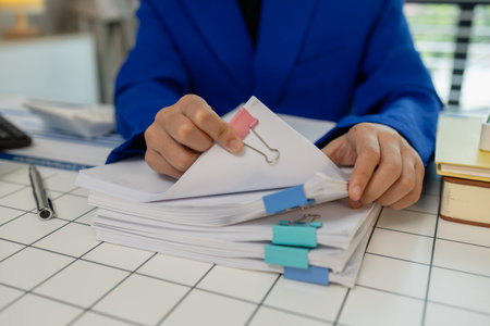 working in the private office, an employee, dealing with a lot of document on the desk, working life, marketing and finance department, an entrepreneur works in her officeの写真素材