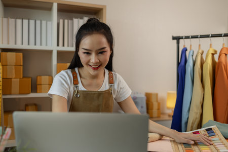 a beautiful female tailor is consulting and talking with a customer to make an agreement that the proposed clothing style matches the customer's requirements, designer, entrepreneur, sewingの写真素材