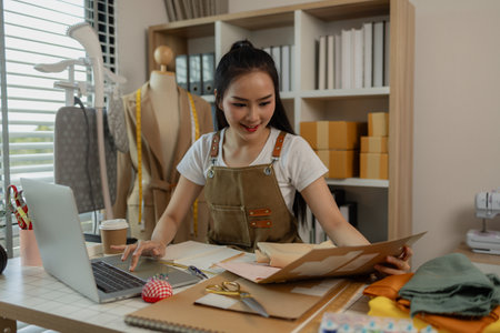 a beautiful female tailor is consulting and talking with a customer to make an agreement that the proposed clothing style matches the customer's requirements, designer, entrepreneur, sewingの写真素材