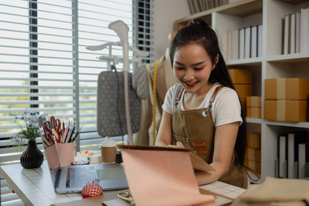 a beautiful female tailor is consulting and talking with a customer to make an agreement that the proposed clothing style matches the customer's requirements, designer, entrepreneur, sewingの写真素材