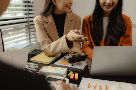 Several employees work together in a company, A group of business people sit together and discuss and exchange ideas about the content of the work, colleagues planning together in the officeの写真素材