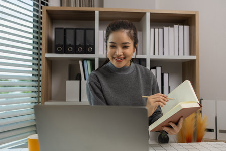 happy woman working on laptop at home office, entrepreneur using laptop at home office, mature businesswoman working from home, beautiful company owner working during isolation periodの写真素材
