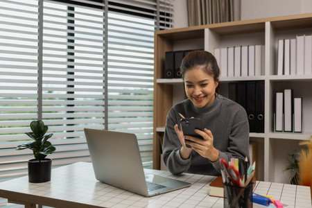 happy woman working on laptop at home office, entrepreneur using laptop at home office, mature businesswoman working from home, beautiful company owner working during isolation periodの写真素材