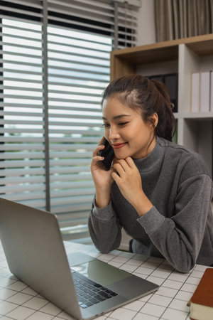 happy woman working on laptop at home office, entrepreneur using laptop at home office, mature businesswoman working from home, beautiful company owner working during isolation periodの写真素材