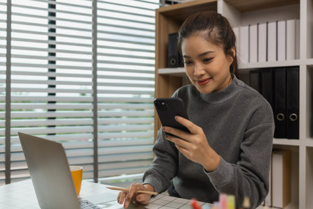 happy woman working on laptop at home office, entrepreneur using laptop at home office, mature businesswoman working from home, beautiful company owner working during isolation periodの写真素材