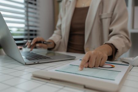 paperwork and report with businesswoman at work in office, computer, data and documents with female staff working on report or online paperwork review, businessperson is working in the officeの写真素材