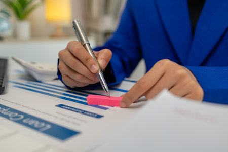 businesswoman is working in her private office with a lot of paperwork, head of marketing and financial department, an entrepreneur, meeting room, a lot of paperwork on the deskの写真素材