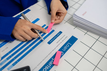 businesswoman is working in her private office with a lot of paperwork, head of marketing and...