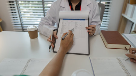 the three doctors are meeting to exchange new knowledge and information they have gained form their medical seminars with each other, a senior doctor is explaining information and knowledgeの写真素材