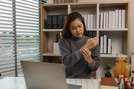 a businesswoman sat at work in her personal office at home for a long time until her body ached severely, the body is injured from working for too longの写真素材