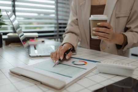 paperwork and report with businesswoman at work in office, computer, data and documents with female staff working on report or online paperwork review, businessperson is working in the officeの写真素材
