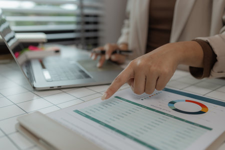 paperwork and report with businesswoman at work in office, computer, data and documents with female staff working on report or online paperwork review, businessperson is working in the officeの写真素材