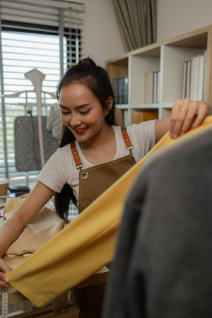 a beautiful female tailor is consulting and talking with a customer to make an agreement that the proposed clothing style matches the customer's requirements, designer, entrepreneur, sewingの写真素材