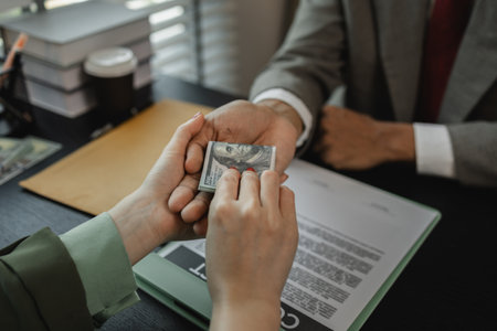 a client is bribing the opposing lawyer in order to win a case, the lawyer is acting unethically and illegally because he is receiving bribes form his client's opponentの写真素材